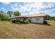 View of home from backyard with a metal roof, complemented by lush greenery at 14555 Se 98Th Ave, Summerfield, FL 34491