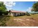 View of home from backyard with a metal roof, complemented by lush greenery at 14555 Se 98Th Ave, Summerfield, FL 34491