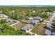 Aerial view showcasing a well-maintained home with a fenced backyard and lush surrounding greenery at 15640 Sw 48 Ave, Ocala, FL 34473
