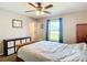 This bedroom features a ceiling fan, carpet flooring, and a window with a view of the outdoors at 15640 Sw 48 Ave, Ocala, FL 34473