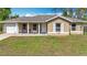 Charming one-story home featuring a covered porch, single car garage, and a well-maintained front lawn at 15640 Sw 48 Ave, Ocala, FL 34473