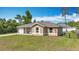 Charming one-story home featuring a covered porch, single car garage, and a well-maintained front lawn at 15640 Sw 48 Ave, Ocala, FL 34473