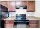 Close-up of the kitchen featuring dark cabinetry, black appliances, and durable countertops at 15640 Sw 48 Ave, Ocala, FL 34473