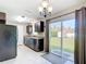 Cozy kitchen with black appliances, dark cabinets, and a view of the backyard through sliding glass doors at 15640 Sw 48 Ave, Ocala, FL 34473