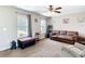 Cozy living room featuring neutral-toned walls and carpet, with a ceiling fan and comfortable seating arrangement at 15640 Sw 48 Ave, Ocala, FL 34473