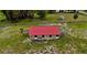 An aerial view of a charming farm with a barn and horses grazing in a lush green pasture at 16850 Se 19Th Ct, Summerfield, FL 34491