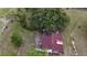 Top-down view of a property with fenced in yard, small building, and mature trees at 16850 Se 19Th Ct, Summerfield, FL 34491