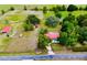 Expansive aerial view of home on sprawling land, barn, fenced yard and mature trees at 16850 Se 19Th Ct, Summerfield, FL 34491