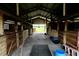 Rustic horse barn interior with wooden beams and stalls, ideal for equestrian enthusiasts at 16850 Se 19Th Ct, Summerfield, FL 34491