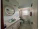 Well-lit bathroom with a sink, bathtub, and toilet, offering essential amenities in a clean and functional space at 16850 Se 19Th Ct, Summerfield, FL 34491