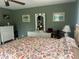 Bedroom with a ceiling fan and decorative artwork on the wall at 16850 Se 19Th Ct, Summerfield, FL 34491