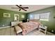 Bedroom featuring green walls, tile flooring, decorated bed, white wood furnishings, and a window view at 16850 Se 19Th Ct, Summerfield, FL 34491
