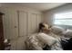 Bedroom with a double closet, a window letting in natural light, and carpeted floors for added comfort at 16850 Se 19Th Ct, Summerfield, FL 34491