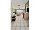 Calm bedroom showcasing a queen bed, tiled floors, and soothing green walls at 16850 Se 19Th Ct, Summerfield, FL 34491