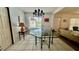 Dining room featuring tile floors, stylish chandelier, and a window view of the pool at 16850 Se 19Th Ct, Summerfield, FL 34491