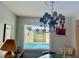 Dining room with chandelier and pool views from a window with decorative glass at 16850 Se 19Th Ct, Summerfield, FL 34491