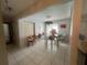 Open-concept dining area featuring tile floors, a chandelier, and seamless flow into the kitchen, ideal for entertaining at 16850 Se 19Th Ct, Summerfield, FL 34491
