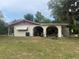 Home exterior with a covered carport, decorative awnings, and a green lawn at 16850 Se 19Th Ct, Summerfield, FL 34491