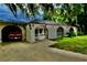 View of the home's exterior with its enclosed pool area and arched entryways at 16850 Se 19Th Ct, Summerfield, FL 34491