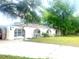 Unique home features a pool enclosure with arched entryways and stucco siding at 16850 Se 19Th Ct, Summerfield, FL 34491