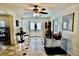 Welcoming foyer with tile flooring, front door, ceiling fan, and neutral walls at 16850 Se 19Th Ct, Summerfield, FL 34491