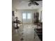Foyer featuring tile floors, double doors, a vintage table and a ceiling fan at 16850 Se 19Th Ct, Summerfield, FL 34491