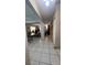 Hallway with tile flooring providing access to the living room, dining room and other rooms at 16850 Se 19Th Ct, Summerfield, FL 34491