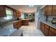 Bright kitchen featuring white appliances, wood cabinets, tile flooring and dining area at 16850 Se 19Th Ct, Summerfield, FL 34491