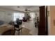 Bright living room featuring tile flooring, ceiling fans, and plenty of natural light from the large windows at 16850 Se 19Th Ct, Summerfield, FL 34491