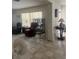 Living room with tile floors, window blinds and neutral wall paint at 16850 Se 19Th Ct, Summerfield, FL 34491