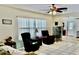 Inviting living area with tile floors, natural light from window with blinds, and ceiling fan at 16850 Se 19Th Ct, Summerfield, FL 34491