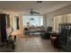 Open living room with tile flooring, ceiling fan, neutral walls and access to other rooms at 16850 Se 19Th Ct, Summerfield, FL 34491