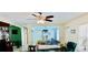 Cozy living room features tile floors, ceiling fan, and a view of the dining room at 16850 Se 19Th Ct, Summerfield, FL 34491
