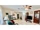 Spacious living room with ceiling fans, tile flooring and a view to other rooms at 16850 Se 19Th Ct, Summerfield, FL 34491