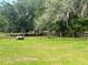 Fenced in pasture with lush green grass and trees at 16850 Se 19Th Ct, Summerfield, FL 34491