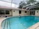 The enclosed pool is accessed by steps and features ladder entry at 16850 Se 19Th Ct, Summerfield, FL 34491