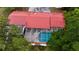 Overhead view of a screened pool enclosure with deck and red roof at 16850 Se 19Th Ct, Summerfield, FL 34491