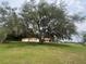 Beautiful property with large trees, a house, and a grassy field at 16850 Se 19Th Ct, Summerfield, FL 34491