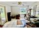 Bright sun room with neutral walls, tile floors, a ceiling fan and outdoor views at 16850 Se 19Th Ct, Summerfield, FL 34491