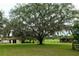 A very old grand tree stands proudly over a well maintained lawn in a picturesque country setting at 16850 Se 19Th Ct, Summerfield, FL 34491