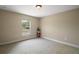A bright and airy bedroom space with neutral walls and carpet, illuminated by a window at 171 Oak Cir, Ocala, FL 34472