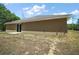 Side view of the home's exterior showcasing a sliding glass door and neutral-toned stucco at 171 Oak Cir, Ocala, FL 34472