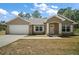 Charming single-Gathering home with a two-car garage, manicured lawn, and well-maintained landscaping at 171 Oak Cir, Ocala, FL 34472