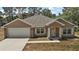 Charming single-Gathering home with a two-car garage, manicured lawn, and well-maintained landscaping at 171 Oak Cir, Ocala, FL 34472
