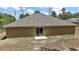 Rear exterior of the home featuring a sliding glass door and a patio, perfect for outdoor entertaining at 171 Oak Cir, Ocala, FL 34472