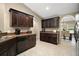 Well-organized kitchen featuring granite countertops, dark wood cabinets, and stainless steel appliances at 171 Oak Cir, Ocala, FL 34472