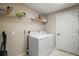 A laundry room with modern appliances, shelving, and a convenient layout at 171 Oak Cir, Ocala, FL 34472