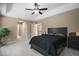 Spacious bedroom with ceiling fan and tray ceiling at 171 Oak Cir, Ocala, FL 34472