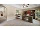 Inviting home office featuring a desk with a chair, piano, bookshelves and a plant for decoration at 171 Oak Cir, Ocala, FL 34472