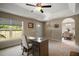 Inviting home office featuring a window for natural light, desk, and doorway to the dining room at 171 Oak Cir, Ocala, FL 34472